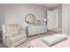 Relaxing bedroom featuring a plush armchair and dresser with decor, bathed in soft, natural light at 13993 N 102Nd St, Scottsdale, AZ 85260