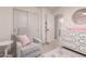 This Bedroom is decorated with a comfortable armchair and a white dresser with gold accents at 13993 N 102Nd St, Scottsdale, AZ 85260