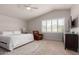 Bright bedroom featuring a large bed, comfortable recliner, and a window showcasing scenic mountain views at 13993 N 102Nd St, Scottsdale, AZ 85260