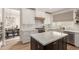 Contemporary kitchen showcasing a center island, modern appliances, white cabinets, and dining area at 13993 N 102Nd St, Scottsdale, AZ 85260