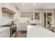 Modern kitchen featuring white cabinets, stainless steel appliances, and a view of the backyard at 13993 N 102Nd St, Scottsdale, AZ 85260