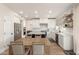 Bright kitchen with an island, modern white cabinets, stainless steel appliances, and adjacent dining area at 13993 N 102Nd St, Scottsdale, AZ 85260