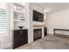 Elegant living room with a stone fireplace, built-in shelving, and neutral decor at 13993 N 102Nd St, Scottsdale, AZ 85260