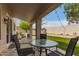 Charming covered patio with outdoor seating, perfect for relaxing and enjoying the beautifully landscaped backyard at 13993 N 102Nd St, Scottsdale, AZ 85260