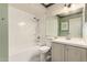 Cozy bathroom featuring a shower-tub combo, toilet, and a vanity with mirror and white cabinets at 1407 W Utopia Rd, Phoenix, AZ 85027