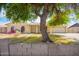 Charming single-story home features a well-manicured front yard and a shady tree at 1407 W Utopia Rd, Phoenix, AZ 85027