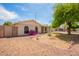 Single-story home with an arid landscaped yard, arched windows and beige stucco exterior at 1407 W Utopia Rd, Phoenix, AZ 85027