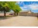 Charming single-story home featuring a spacious driveway, two-car garage, and a mature shade tree at 1407 W Utopia Rd, Phoenix, AZ 85027