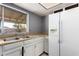 Functional kitchen featuring ample counter space, white appliances, and a window with backyard view at 1407 W Utopia Rd, Phoenix, AZ 85027