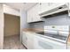 Kitchen with classic white cabinets, stove with white range hood and tile flooring at 1407 W Utopia Rd, Phoenix, AZ 85027
