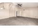 Bright living room with arched doorway, carpet flooring, and ceiling fan for added comfort at 1407 W Utopia Rd, Phoenix, AZ 85027