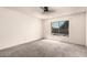 Spacious main bedroom with carpet floors, ceiling fan, and a window offering natural light at 1407 W Utopia Rd, Phoenix, AZ 85027