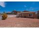 Spacious backyard featuring desert landscaping and an enclosed patio at 14244 N 132Nd Ln, Surprise, AZ 85379