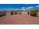 Backyard featuring low-maintenance desert landscaping, a block wall, and two sheds at 14244 N 132Nd Ln, Surprise, AZ 85379