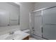 Bright bathroom featuring a white vanity and a shower with a sliding glass door at 14244 N 132Nd Ln, Surprise, AZ 85379