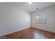 An empty bedroom with wood laminate flooring and a window for natural light at 14244 N 132Nd Ln, Surprise, AZ 85379