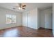 Light-filled bedroom with wood-look flooring and window brings in natural light and adds warmth at 14244 N 132Nd Ln, Surprise, AZ 85379
