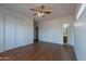 Spacious bedroom with wood-look floors offers access to a closet and an ensuite bathroom at 14244 N 132Nd Ln, Surprise, AZ 85379
