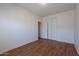 A bright bedroom featuring wood floors, a closet, and white walls, ready for customization at 14244 N 132Nd Ln, Surprise, AZ 85379