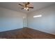 A well-lit bedroom offers flexible space, wood floors and neutral tones for easy personalization at 14244 N 132Nd Ln, Surprise, AZ 85379