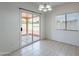Bright dining area with tile floors and access to the backyard through sliding glass doors at 14244 N 132Nd Ln, Surprise, AZ 85379