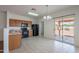 Dining area with tile flooring and sliding glass doors that lead to a covered patio at 14244 N 132Nd Ln, Surprise, AZ 85379