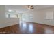 Open-concept living area with wood floors, neutral walls, and lots of light at 14244 N 132Nd Ln, Surprise, AZ 85379