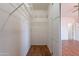 Walk-in closet boasts ample storage space with its built-in wire shelving system at 14244 N 132Nd Ln, Surprise, AZ 85379