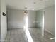 Bright living room with stylish tile flooring, modern light fixture, and ample natural light at 14300 W Bell Rd # 57, Surprise, AZ 85374