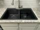 Modern black double basin sink with stainless steel faucet and granite countertop at 14300 W Bell Rd # 57, Surprise, AZ 85374
