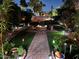 Charming backyard features an outdoor fire pit and lush landscaping with garden lights at 14605 S 35 Pl, Phoenix, AZ 85044