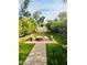 Beautiful backyard featuring an outdoor fire pit, lush landscaping, and charming brick patio at 14605 S 35 Pl, Phoenix, AZ 85044