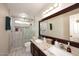 Modern bathroom with a double vanity, granite countertops, and a tiled glass enclosed shower at 14605 S 35 Pl, Phoenix, AZ 85044