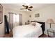 Comfortable bedroom with a ceiling fan, a comfortable bed, and warm terracotta tile flooring at 14605 S 35 Pl, Phoenix, AZ 85044