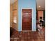 Foyer with tile floors, wooden front door, and views of the living area, creating a warm and inviting entrance at 14605 S 35 Pl, Phoenix, AZ 85044