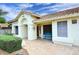 Inviting front porch with tile flooring, blue bench, and decorative sun accent under a partly cloudy sky at 14605 S 35 Pl, Phoenix, AZ 85044