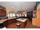 Open kitchen featuring terra cotta floors, kitchen island, and is open to the Gathering room at 14605 S 35 Pl, Phoenix, AZ 85044