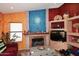 Living room featuring fireplace, tile flooring, and custom built-ins at 14605 S 35 Pl, Phoenix, AZ 85044