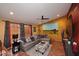Comfortable living room with an oversized sectional sofa, ottoman, and terracotta floors for a cozy atmosphere at 14605 S 35 Pl, Phoenix, AZ 85044