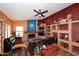 Spacious living room featuring a fireplace, tile flooring and custom built-ins at 14605 S 35 Pl, Phoenix, AZ 85044