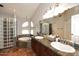 Main bathroom with double sinks, tub, and glass block shower at 14605 S 35 Pl, Phoenix, AZ 85044