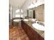 Bathroom with double sinks, glass block shower and terra cotta flooring at 14605 S 35 Pl, Phoenix, AZ 85044