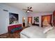 Primary bedroom with terra cotta flooring, ceiling fan and ensuite bathroom at 14605 S 35 Pl, Phoenix, AZ 85044