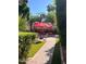 Beautiful pool area with a vibrant pool, red patio umbrellas, and comfortable seating at 14605 S 35 Pl, Phoenix, AZ 85044