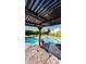 Covered patio with an outdoor dining table overlooking the sparkling pool at 14605 S 35 Pl, Phoenix, AZ 85044