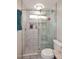 Modern tiled shower with glass enclosure, built-in shelves, and elegant fixtures at 14605 S 35 Pl, Phoenix, AZ 85044