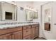 Bathroom boasting dual sinks with granite counters and wood cabinets with modern fixtures at 1523 E Tulsa St, Chandler, AZ 85225