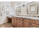 Bathroom boasting dual sinks with granite counters, modern fixtures, and decorative mirrors at 1523 E Tulsa St, Chandler, AZ 85225