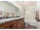 Bathroom with dual sinks, granite countertop, and a shower-tub combo with modern fixtures at 1523 E Tulsa St, Chandler, AZ 85225