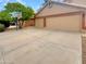 Spacious driveway leading to a two-car garage with a basketball hoop on the side at 1523 E Tulsa St, Chandler, AZ 85225